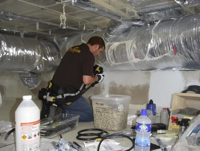 Seekonk Air Duct Cleaning specialist performing professional mold removal from air ducts in Seekonk