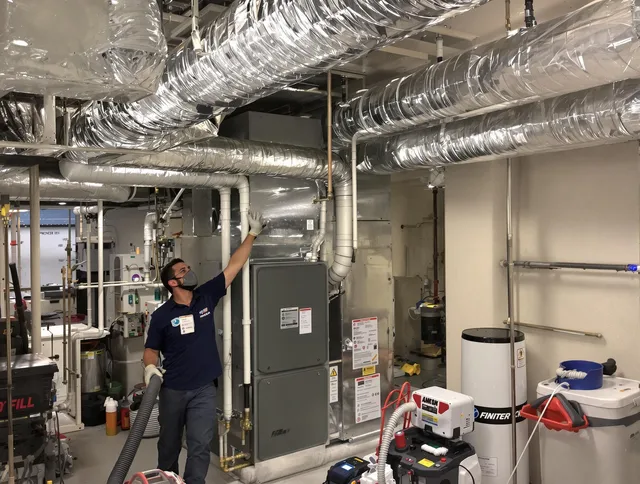 Seekonk Air Duct Cleaning specialist performing thorough furnace duct cleaning in a Seekonk residence