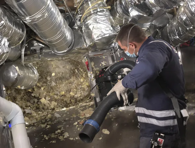 Seekonk Air Duct Cleaning specialist operating negative pressure cleaning equipment for thorough duct maintenance in Seekonk