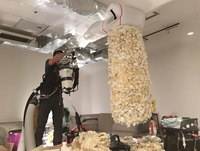 Seekonk Air Duct Cleaning technician performing precision vacuum insulation removal in a residential property in Seekonk